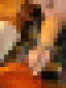 Eine Hand putzt liebevoll den Korpus eines Streichinstruments in einer Werkstatt.